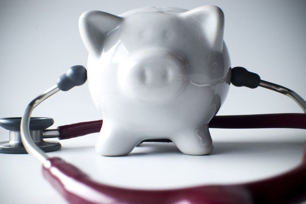 A piggybank with a stethoscope